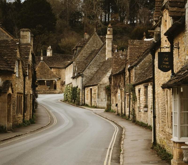 Charming Cotswolds street with traditional stone cottages in England