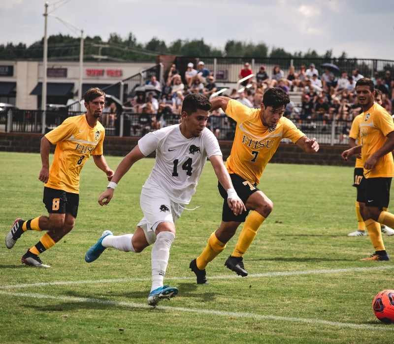 exciting football match with players competing on a crowded stadium field