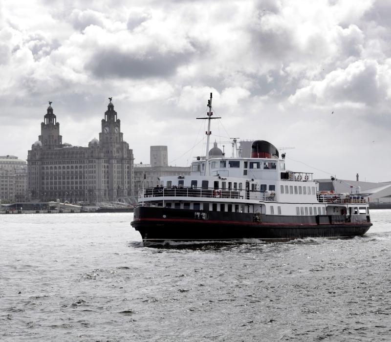 River Mersey cruise ferry and Liverpool waterfront skyline