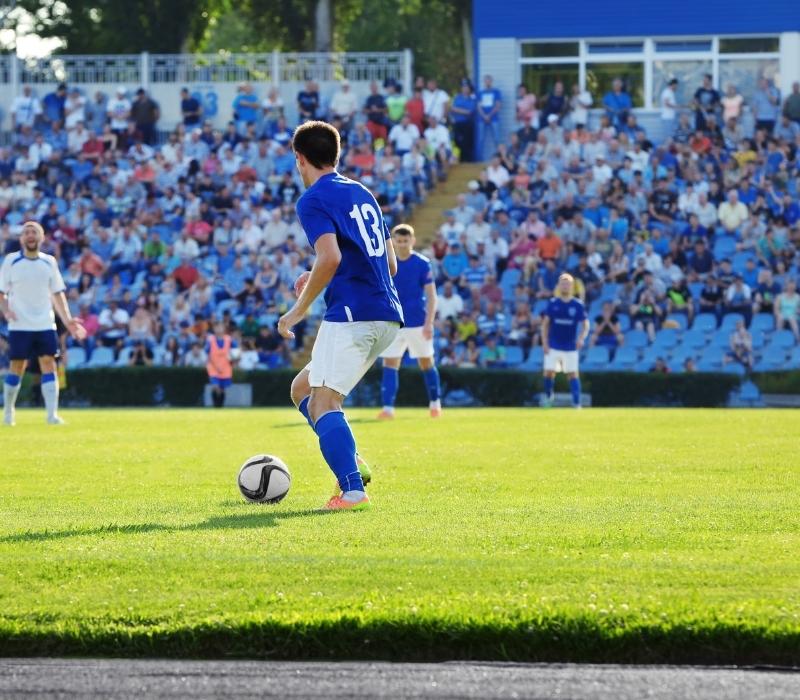 Live football match experience during a father and son UK soccer tour with fans enjoying the action from the stadium