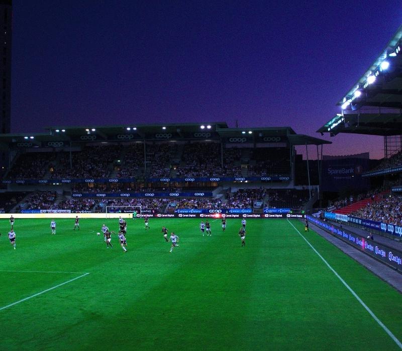 Soccer player on a green soccer field during a match at night