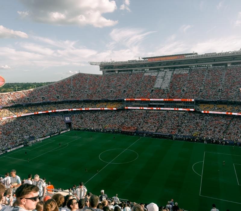 Packed football stadium filled with fans watching an exciting soccer match